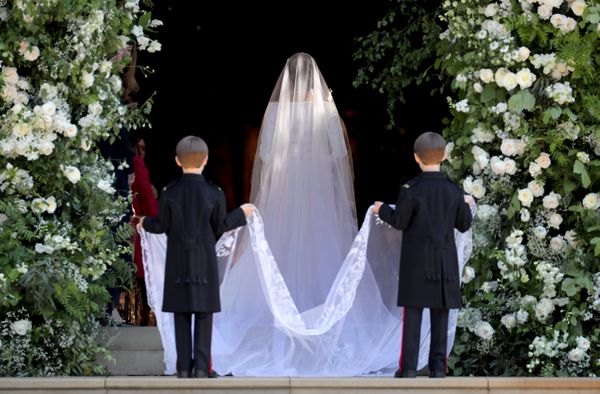Pageboys hold the train of the dress of Meghan Markle as she arrives at St. George's Chapel.