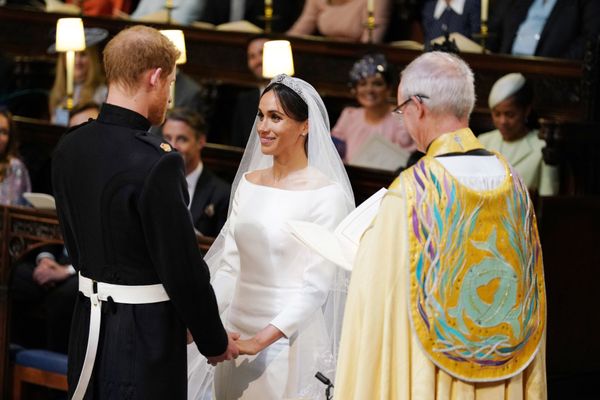 The couple holding hands during their wedding service, conducted by the Archbishop of Canterbury Justin Welby.