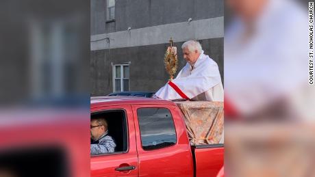 A priest rode around in the back of a pickup truck blessing people in Philadelphia