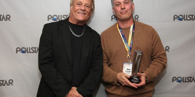 Bad Company's Briane Howe and Comedy Tour of the Year Award recipient Rick Greenstein pose backstage during the 26th Annual PollStar Awards at Ryman Auditorium on Feb. 21, 2015 in Nashville, Tenn.