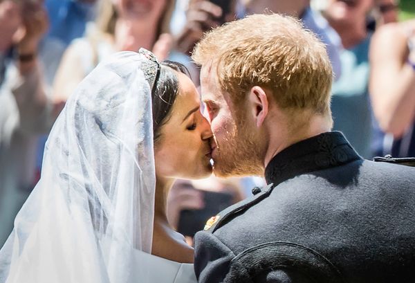 The Duke and Duchess of Sussex kiss as they leave from the West Door of St. George's Chapel after their wedding ceremony.