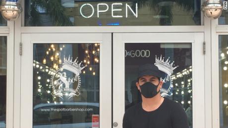 Mike Risco, CEO of The Spot Barber Shop in Doral, Florida, reopened his shop Monday.
