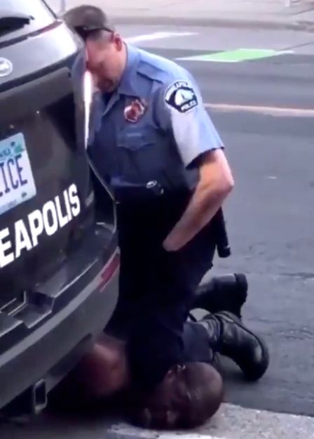 Video captured by a bystander appears to show a Minneapolis police officer pressing his knee into the neck of a handcuffed Bl