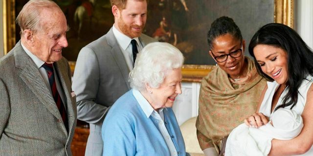 In this image made available by SussexRoyal on Wednesday, May 8, 2019, Britain's Prince Harry and Meghan, Duchess of Sussex, joined by her mother Doria Ragland, show their new son to Queen Elizabeth II and Prince Philip at Windsor Castle, Windsor, England. Prince Harry and Meghan have named their son Archie Harrison Mountbatten-Windsor.