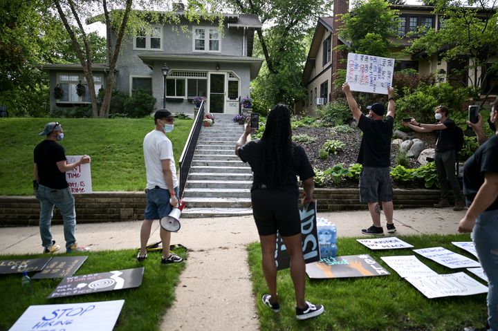 Protesters angered by the death of George Floyd stand Wednesday outside the home of Hennepin County Attorney Mike Freeman in 
