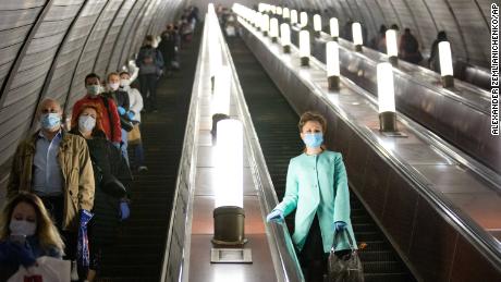 People wearing face masks and gloves on a subway escalator in Moscow on Tuesday.