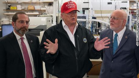 President Donald Trump speaks next to US Health and Human Service Secretary Alex Azar and CDC Director Robert Redfield  during a tour of the Centers for Disease Control and Prevention on March 6, 2020. 