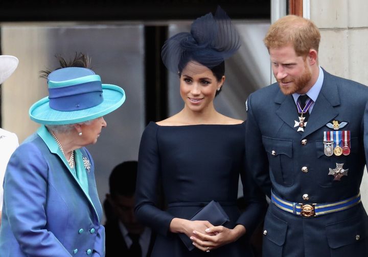 Queen Elizabeth II and the Duke and Duchess of Sussex chat on the balcony of Buckingham Palace on July 10, 2018.