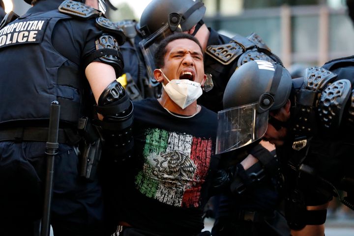 A demonstrator is taken into custody by police near the White House in Washington after a curfew took effect on June 1.