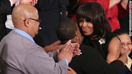 Then first lady Michelle Obama hugs Cleopatra Cowley-Pendleton and Nathaniel A. Pendleton Sr. of Chicago before then President Barack Obama&#39;s State of the Union speech at the U.S. Capitol February 13, 2013 in Washington, DC. The Pendleton&#39;s daughter, Hadiya Pendleton, was murdered on January 29, 2013, when she was shot and killed in Harsh Park on Chicago&#39;s South Side. 
