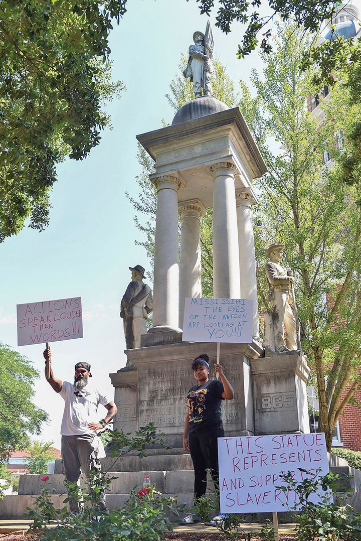 John Lewis, left, and Sonniah Ramirez, 12, protest for the removal of the Confederate monument that stands on the Lowndes Cou