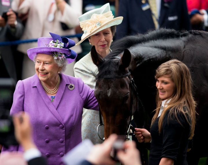 Princess Anne looks on as Queen Elizabeth II pats her Gold Cup winning horse Estimate on Ladies Day of Royal Ascot on June 20
