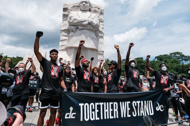 Members of the Washington Wizards and Washington Mystics basketball teams rally at the Martin Luther King Jr. Memorial in Was