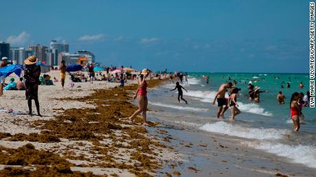 People enjoy a sunny day in Miami Beach, Florida, on June 16, 2020.