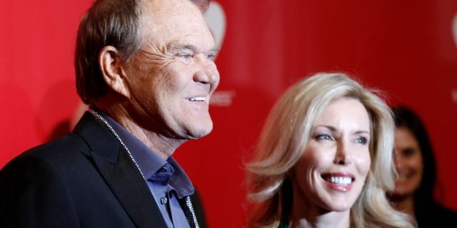 Musician Glen Campbell (L) and wife Kim Woollen pose at the 2012 MusiCares Person of the Year tribute honoring Paul McCartney in Los Angeles, Calif. on February 10, 2012.