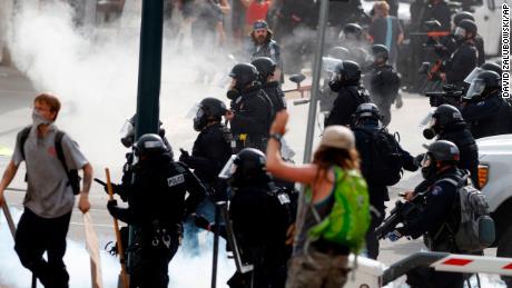 Denver Police advance after firing tear gas canisters during a protest outside the State Capitol over the death of George Floyd, on May 30.