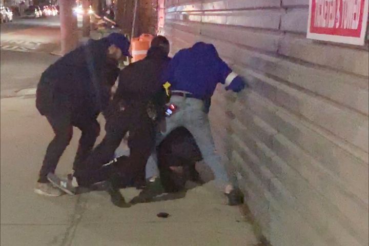 In this image made from video, New York City police officers forcefully arrest 20-year-old Fitzroy Gayle in the Brooklyn boro