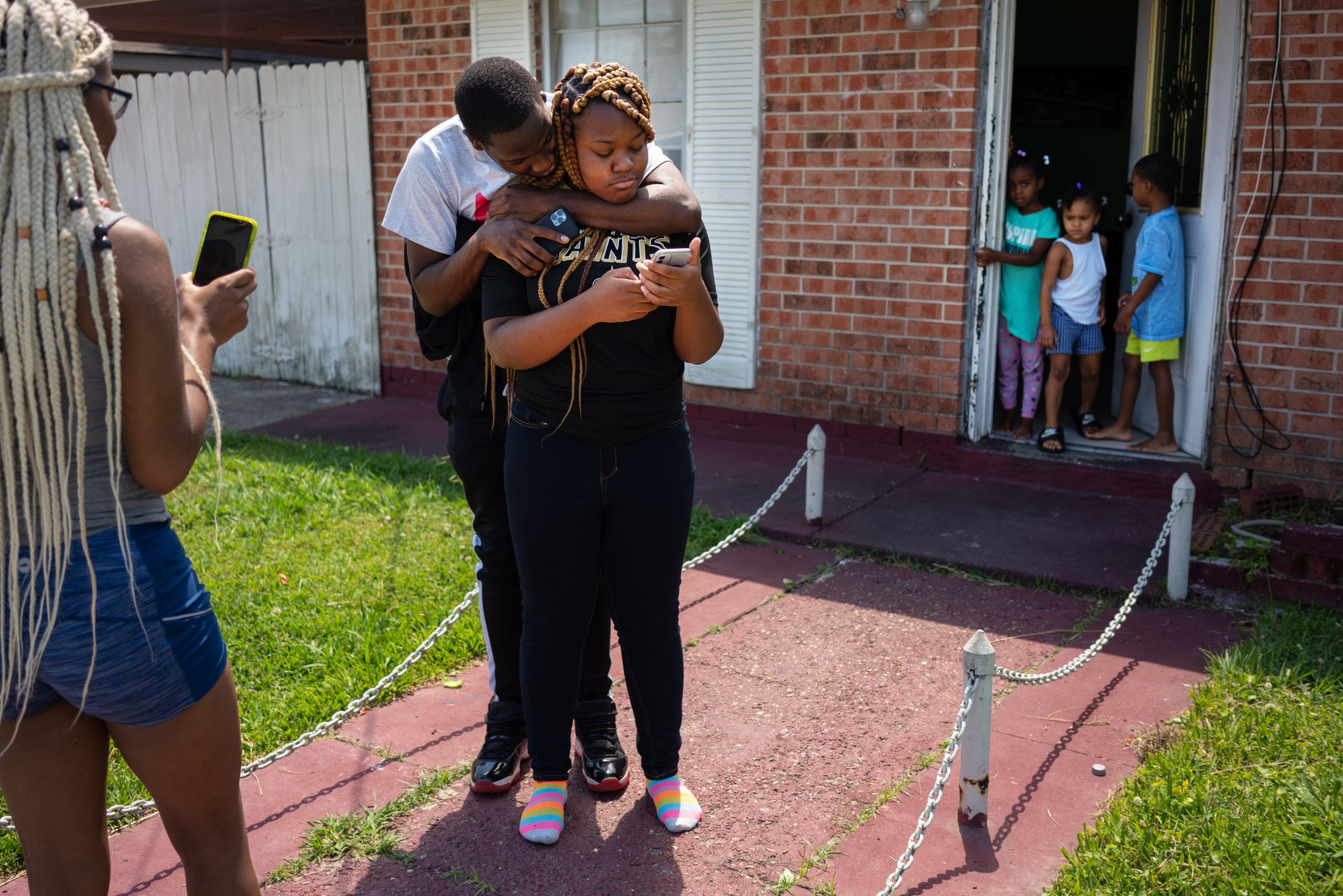 Troynique Turner, left, and Troy Green Jr. try to console their sister, Trevianne, who had just found out over a Zoom call th