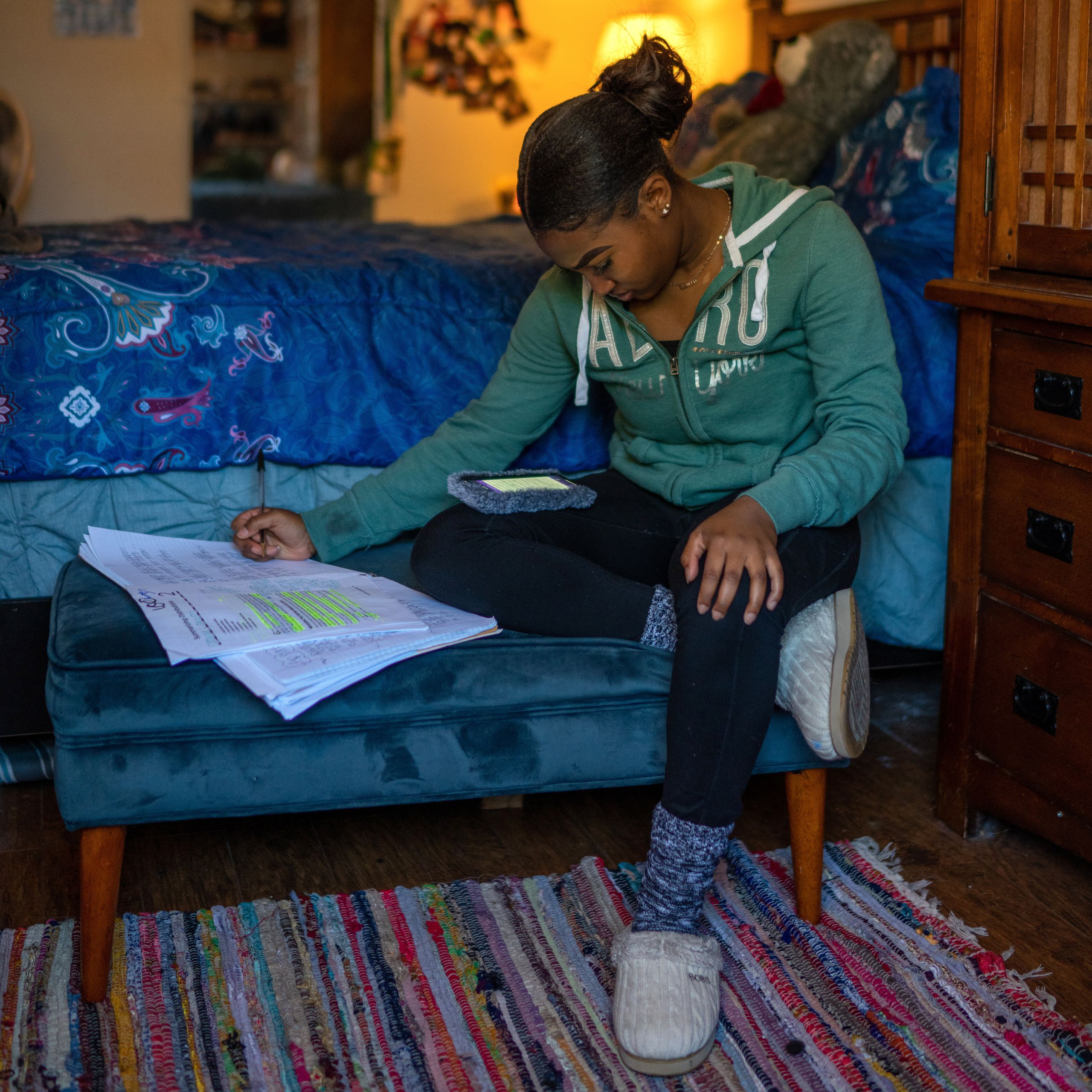 Satoriya Lambert does homework in her room after the coronavirus shuttered schools for the rest of the year in New Orleans. S