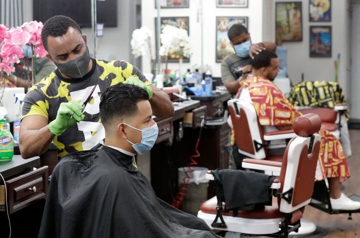 Barbers in&nbsp; Florida wear masks to protect against the coronavirus while at work on May 21.&nbsp;Personal grooming shops 