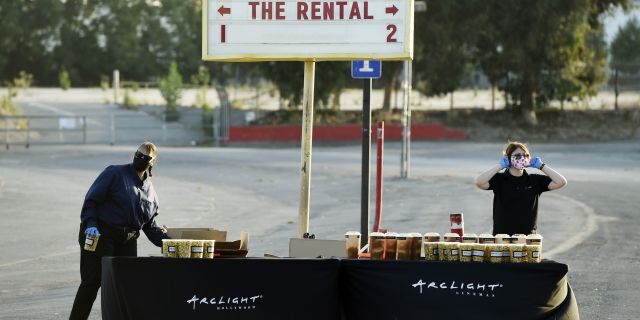 Workers prepare to hand out concessions to drivers before an advance screening of the film "The Rental" at Vineland Drive-In, Thursday, June 18, 2020, in City of Industry, Calif. (AP Photo/Chris Pizzello)