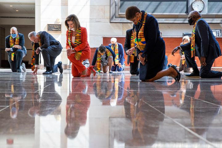House Speaker Nancy Pelosi of Calif., center, and other members of Congress, kneel and observe a moment of silence at the Cap