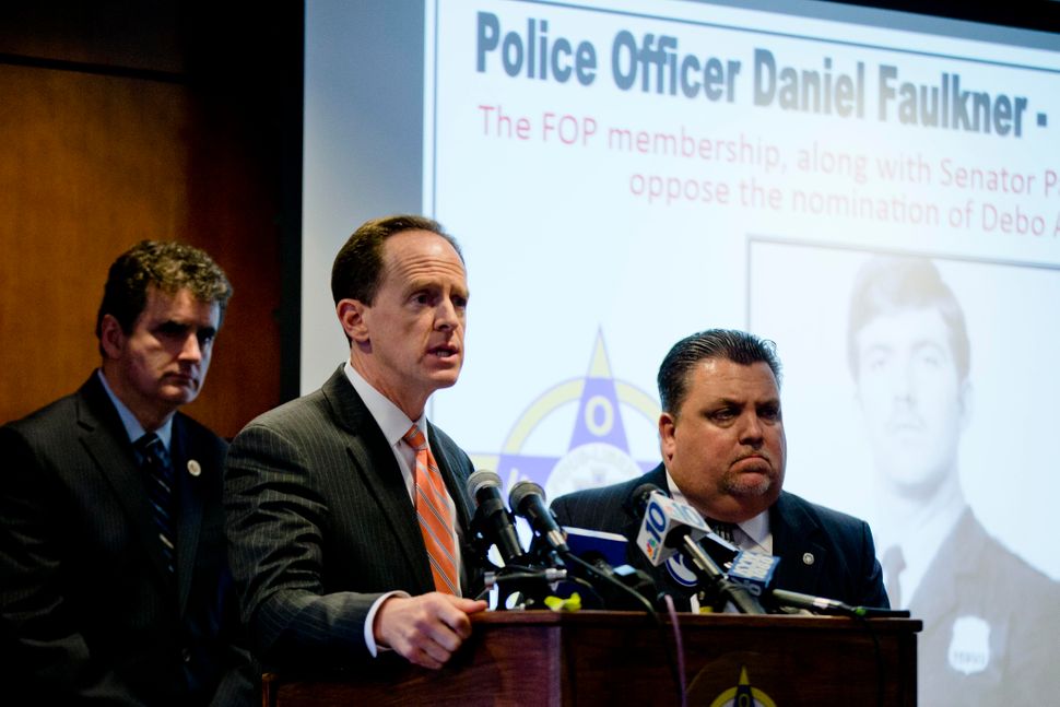 Sen. Pat Toomey (R-Pa.), center, and Rep. Mike Fitzpatrick (R-Pa.), left, were joined by the Fraternal Order of Police's&nbsp