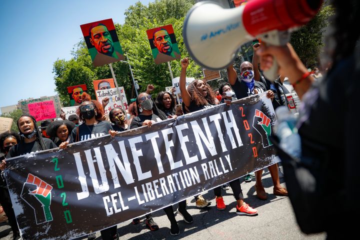 Protesters chant as they march after a Juneteenth rally at the Brooklyn Museum Friday.