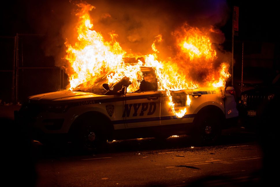 A New York Police Department SUV is burned Sunday during a Brooklyn protest over the police killing of George Floyd in Minnea