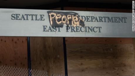 A defaced sign for the East Precinct reads &quot;Seattle People Department&quot; on Wednesday in Seattle.
