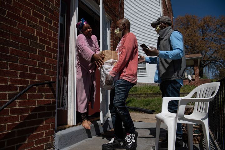 Volunteers deliver groceries to a woman in Washington, D.C., on April 6 amid the coronavirus pandemic. They knew where to go 