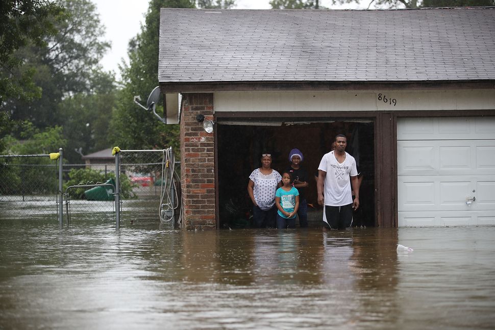 People in Houston wait to be rescued from their flooded homes after the area was inundated by Hurricane Harvey on Aug. 28, 20