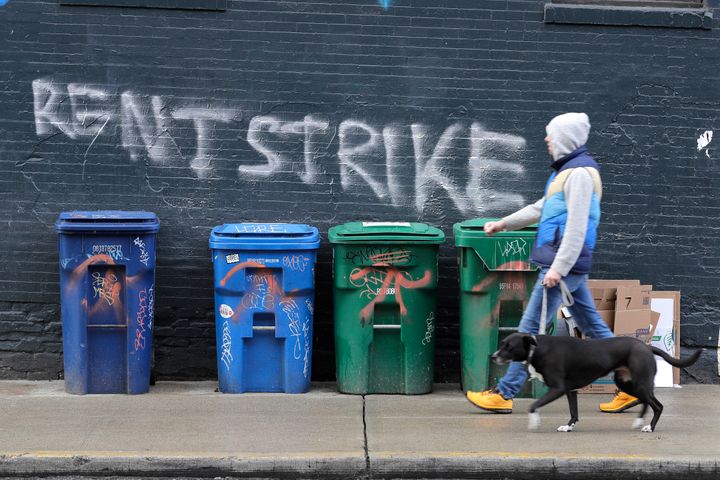 A pedestrian walks past graffiti in Seattle's Capitol Hill neighborhood. With millions of people suddenly out of work, some t