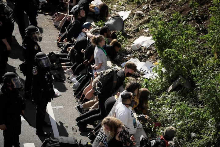 FILE&mdash;In this file photo from June 1, 2020, police detain protesters along Interstate 676 in Philadelphia in the afterma