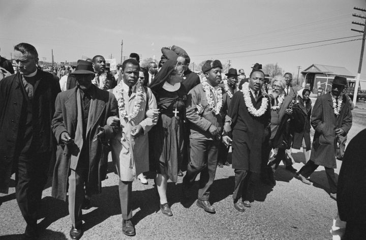 John Lewis seen third to the left with Dr Martin Luther King Jr. as they begin the Selma to Montgomery civil rights march fro