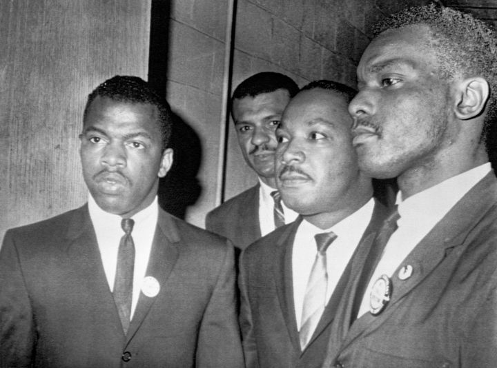 Reverend Martin Luther King Jr., (center) is escorted into a mass meeting at Fisk University in Nashville. His colleagues are