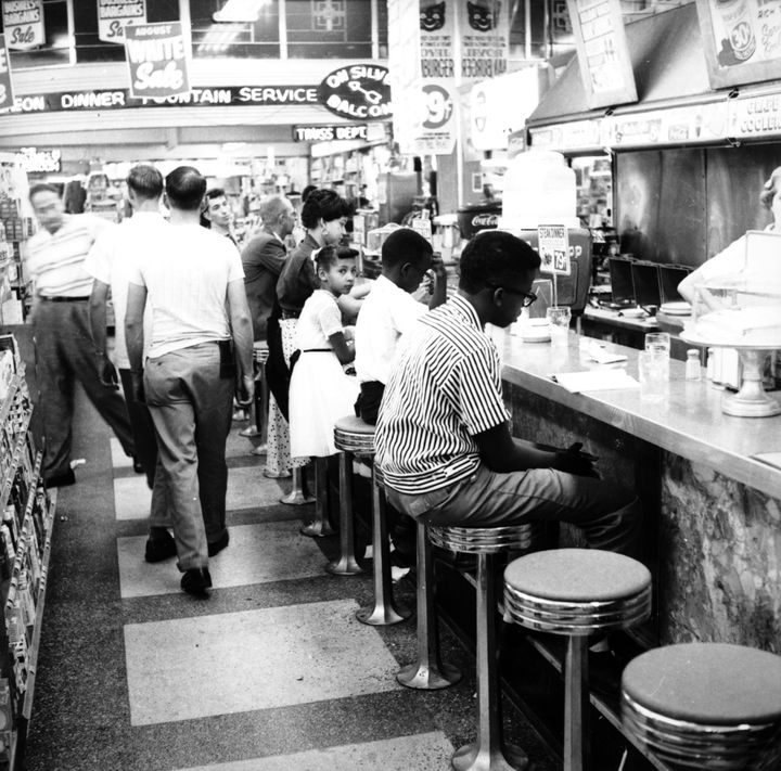 Demonstrators participate in a sit-in to protest the segregation of lunch counters across the nation.