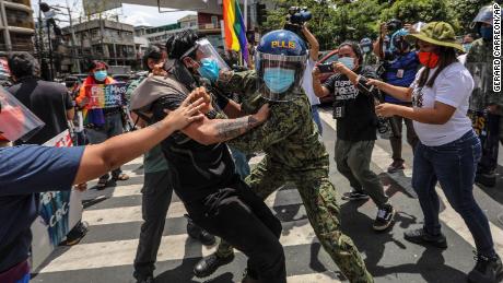 Police clash with protesters during a LGBTQ pride march in Manila, Philippines, on June 26, 2020. Demonstrators were also protesting the country&#39;s new anti-terror law.