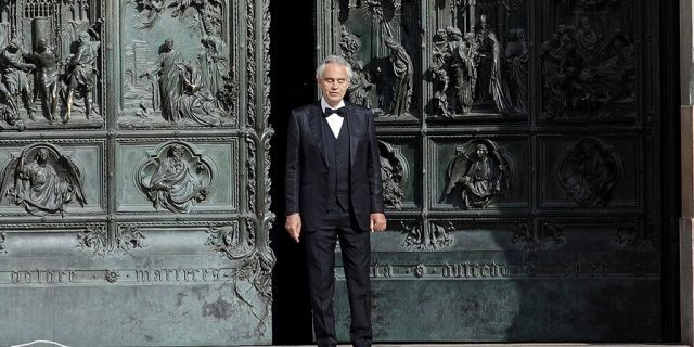 FILE - In this Sunday, April 12, 2020, Italian singer Andrea Bocelli performs outside the Duomo cathedral, in Milan, Italy. (AP Photo/Luca Bruno, File)