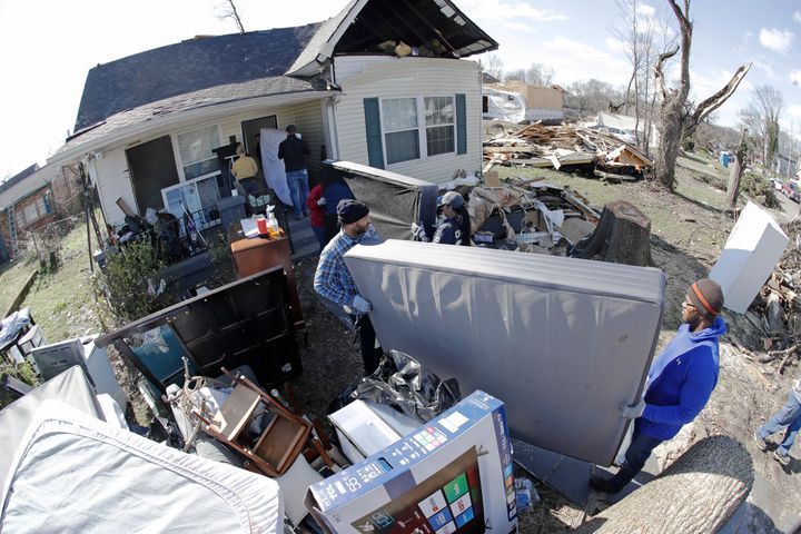 A group of volunteers moves items salvaged from a damaged home on March 6 in Nashville, Tennessee.