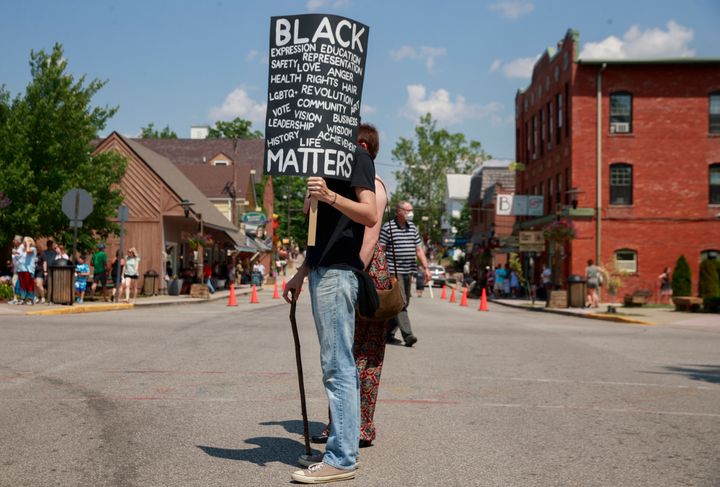 A man holds a placard during a demonstration in solidarity with Black Lives Matter in Nashville, Indiana, on&nbsp;June 20. Na
