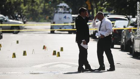 Police work a crime scene in Brooklyn where a 1-year-old boy was killed July 13 when gunfire erupted at a family picnic. 