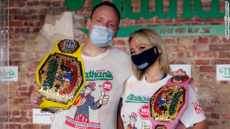 Competitive eaters Joey Chestnut and Miki Sudo after winning their respective divisions with new world records at the Nathan&#39;s Famous Hot Dog Eating Contest on Saturday.