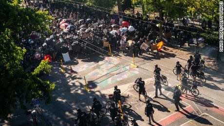 Police push demonstrators back atop a Black Lives Matter street mural in the area formerly known as CHOP during protests in Seattle on July 25, 2020 in Seattle, Washington.