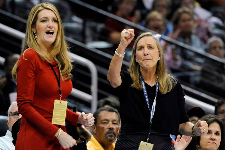 Kelly Loeffler (left), cheers on the Atlanta Dream basketball team, which she co-owns, during a game. She has become an outsp
