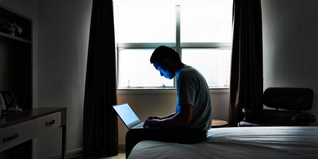 Craning over laptops on the bed or couch with rounded shoulders fatigues the muscles and predisposes the body to injury, experts say. (iStock)