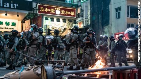 Riot police are seen in front of a burning road block during a protest against the new national security law on July 1, 2020, in Hong Kong. 