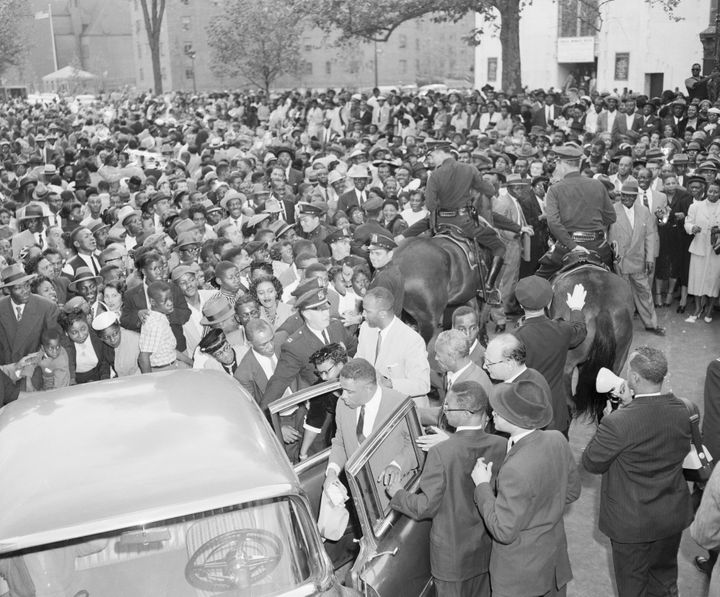 People in New York gather around Mamie Bradley, the mother of Emmett Till, to protest the acquittal of her son's murderers in