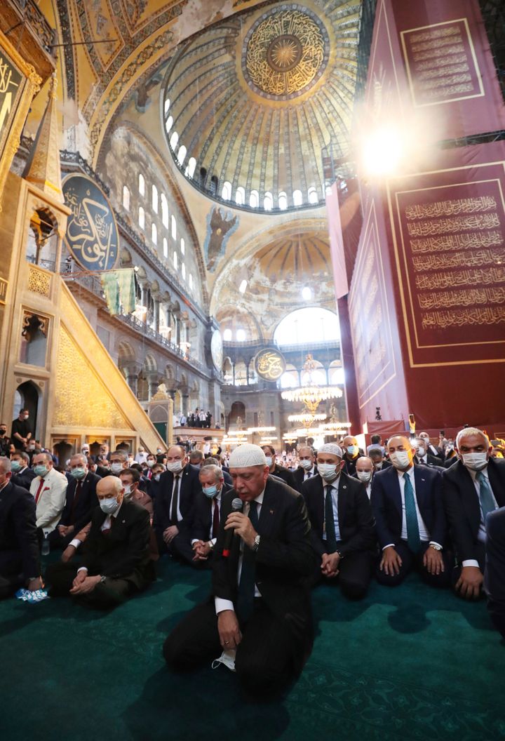 Turkey's President Recep Tayyip Erdogan, center, recites from the Quran during Friday prayers in Hagia Sophia on July 24, 202