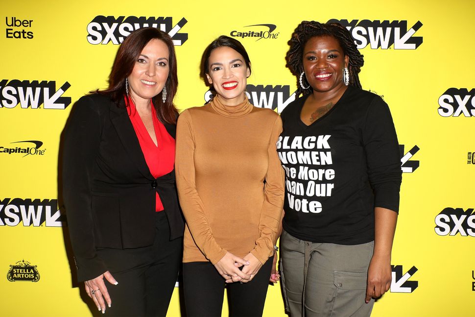 Cori Bush, right, joins Amy Vilela, left, and Rep. Alexandria Ocasio-Cortez (D-N.Y.) at the premiere of the documentary "Knoc